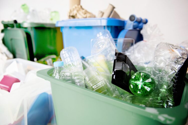 Bins filled with assorted plastic bottles and containers ready for recycling, ideal for efficient waste removal services.